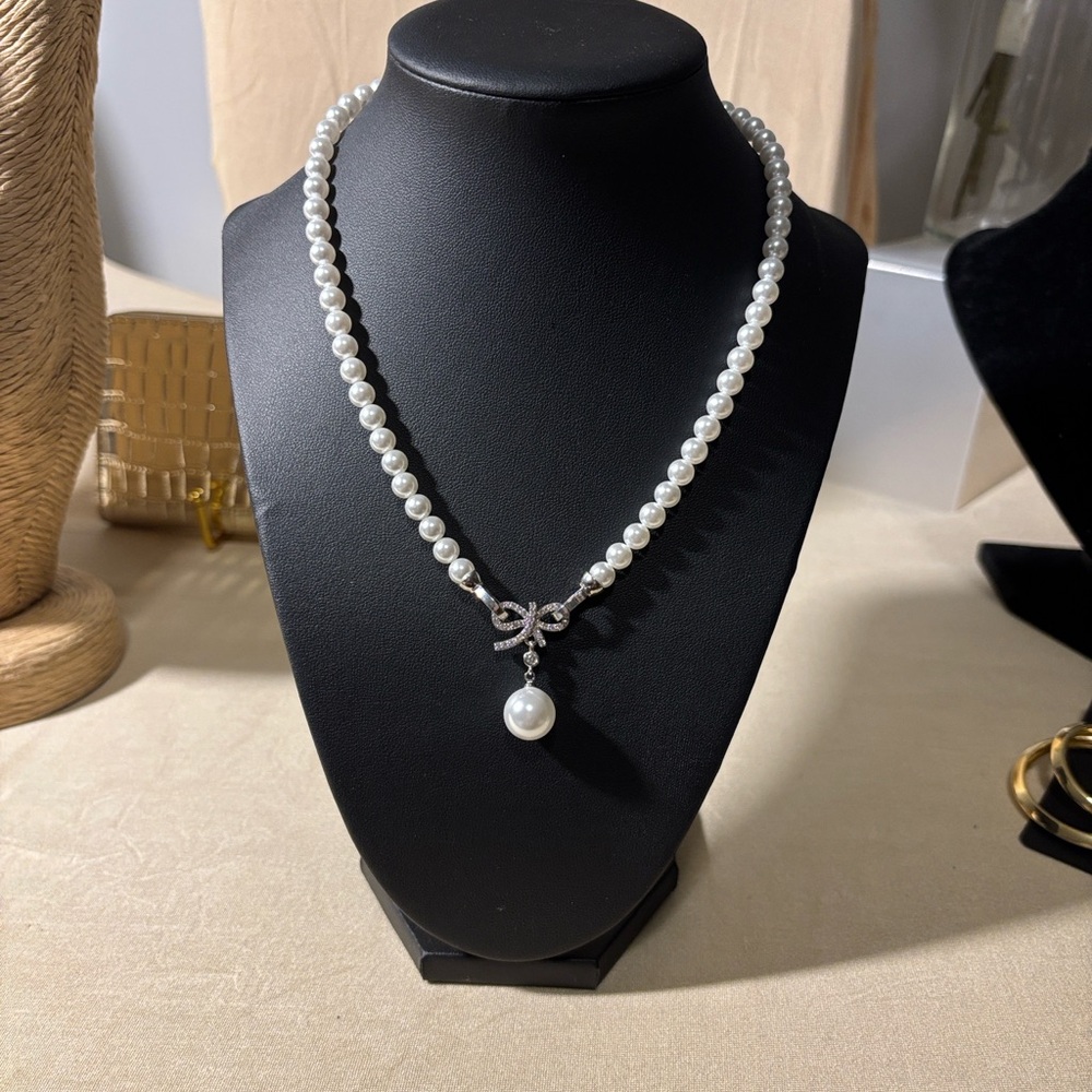 Elegant Pearl Necklace with Bow Pendant